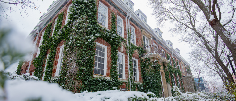 A side view of the hutt building on a snowy day.