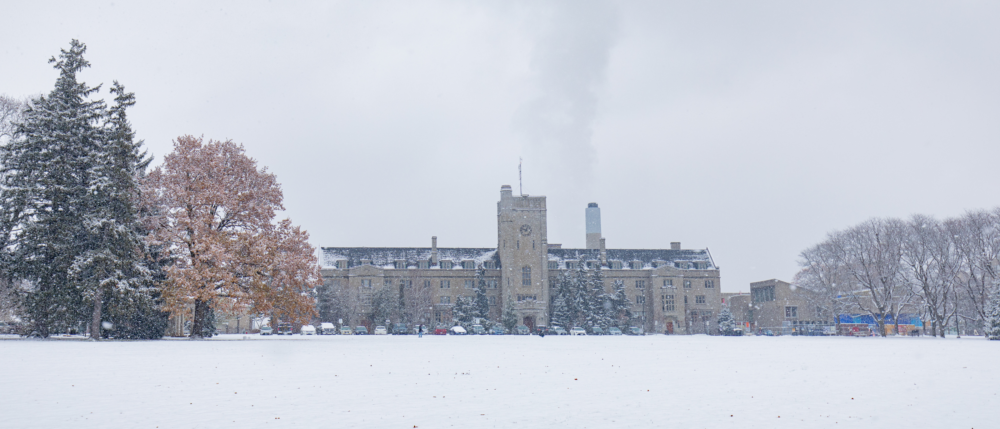 View of Johnston Hall across Johnston Green on a snowy, cloudy day.