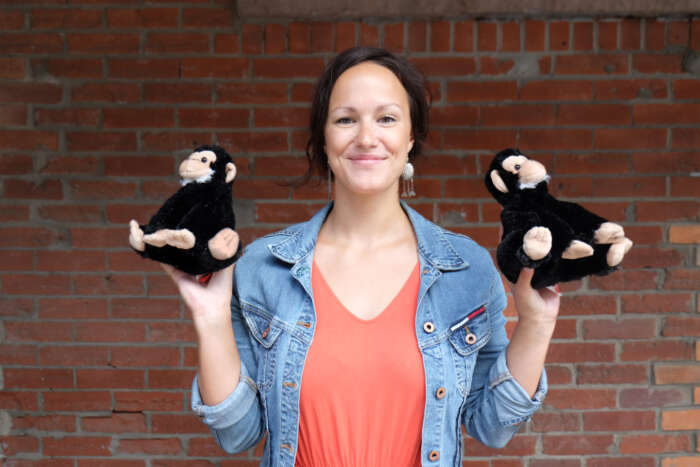 Marie Meloche holds up two stuffed monkeys.