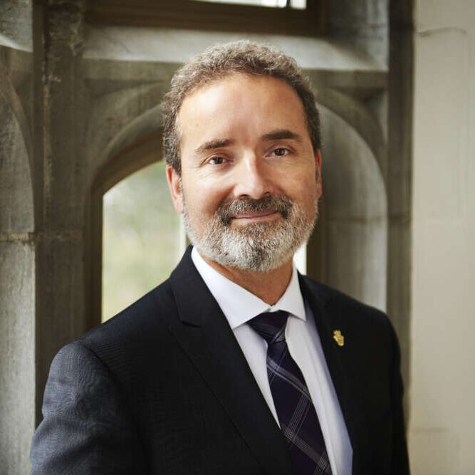 Dr. Rene Van Acker againast an institutional background