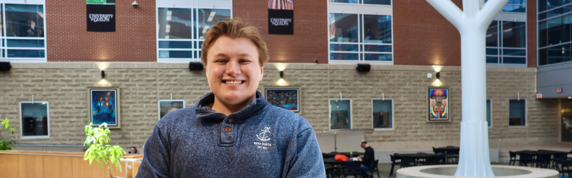 Benjamin Snetsinger poses in U of G atrium