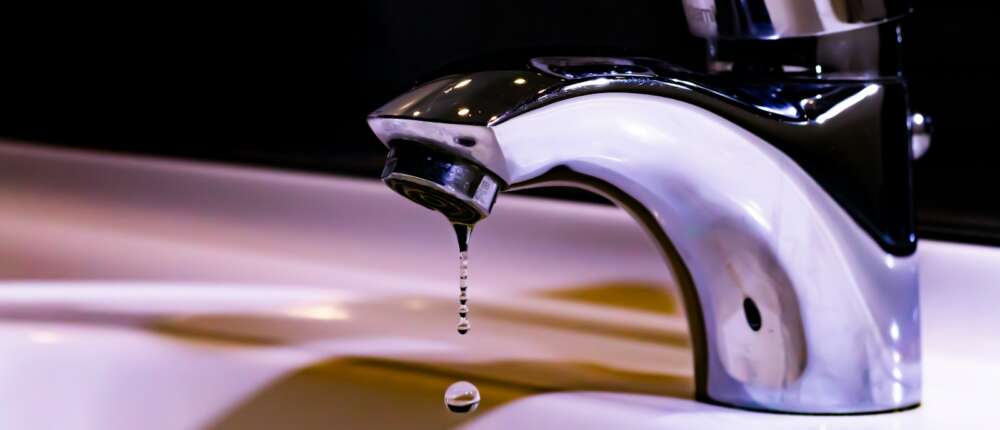 stainless steel faucet on white ceramic sink