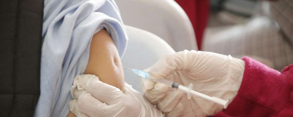 a person in a red shirt and white gloves