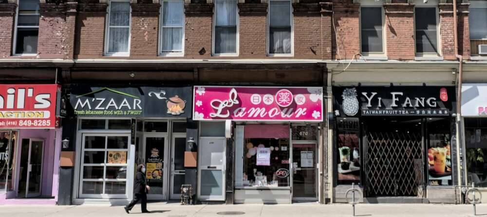 a Toronto street with many storefronts and restaurants