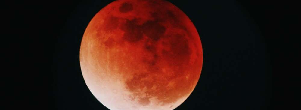 red moon in a black night sky