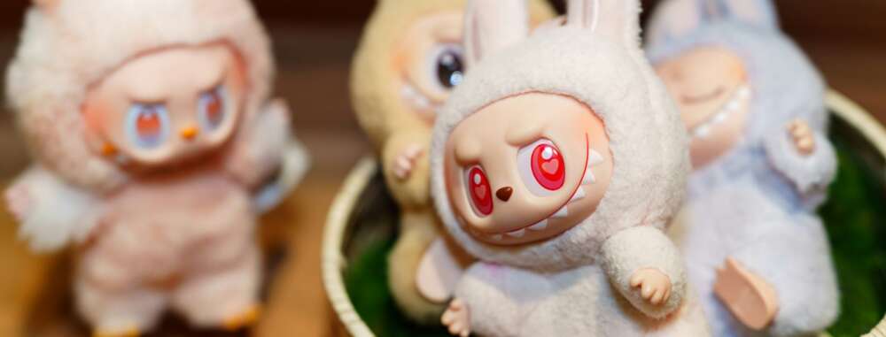 cream coloured dolls with red eyes and pointy teeth are shown