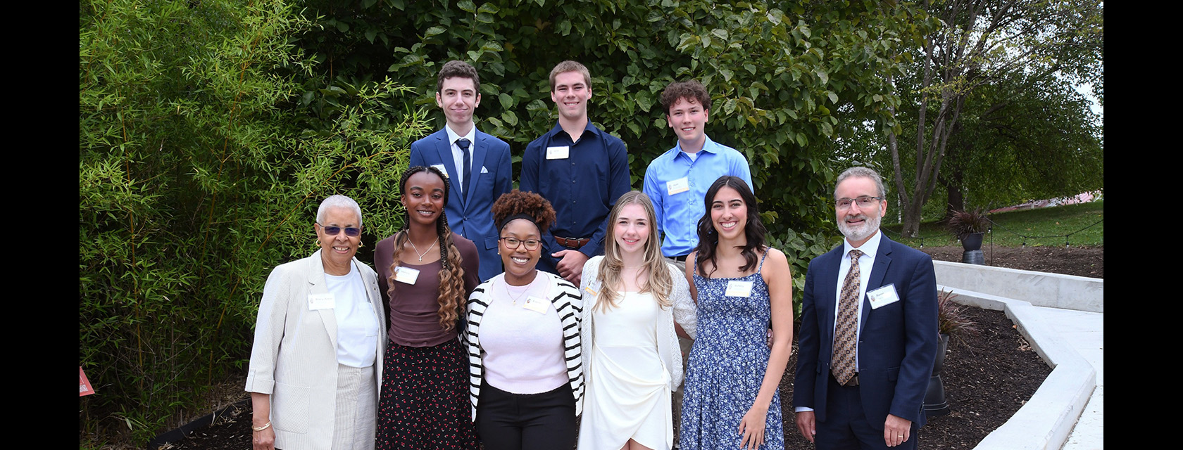 seven students pose outside with U of G Chancellor Mary-Anne Chambers and President Rene van Acker
