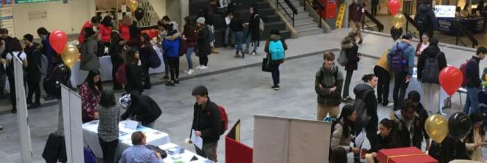 Students visit tables at the financial literacy fair in the UC Courtyard
