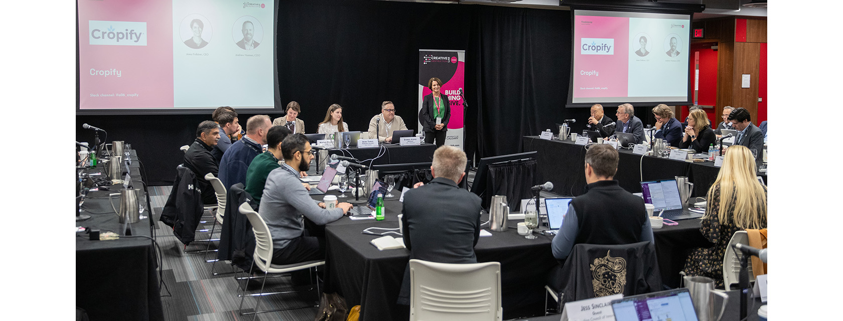 The backs of a dozen people with laptops at a CDL-Rockies presentation