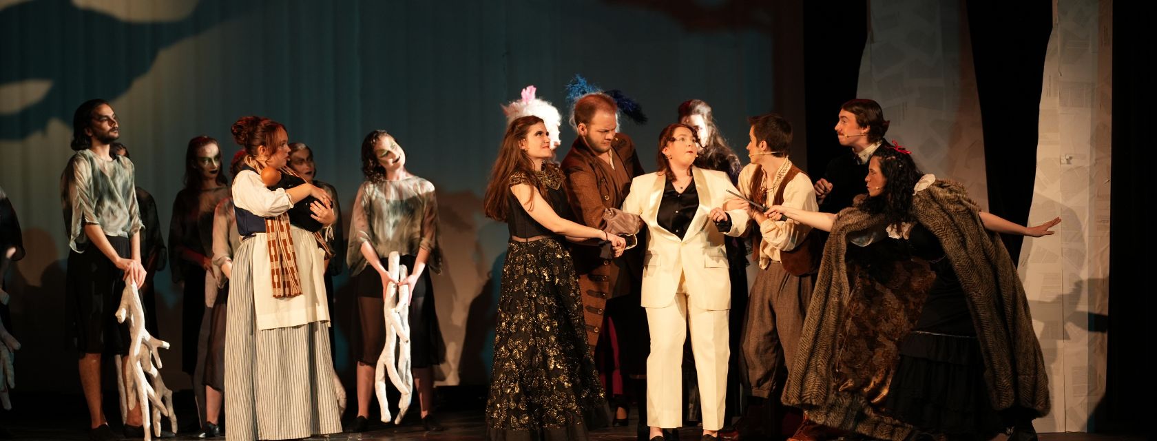 people in costume perform on stage
